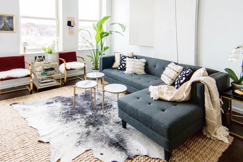 Living room with layered rugs in different colors and textures.
Living room with layered rugs in different colors and textures.