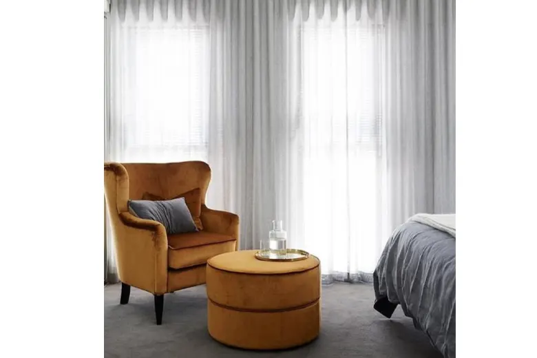 A carpeted bedroom design with sheer curtains A carpeted bedroom design with sheer curtains
