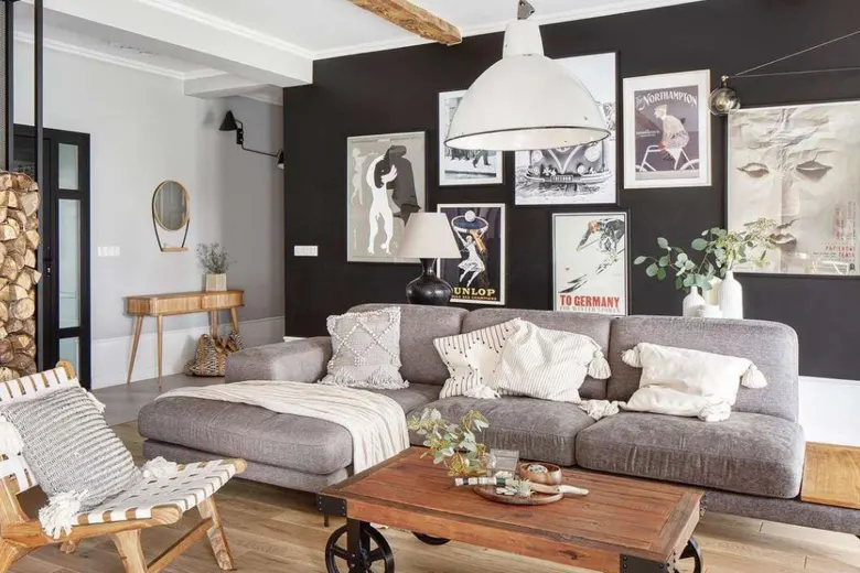 Living room with a black accent wall, wooden furniture, and neutral-coloured decor.
Living room with a black accent wall, wooden furniture, and neutral-coloured decor.