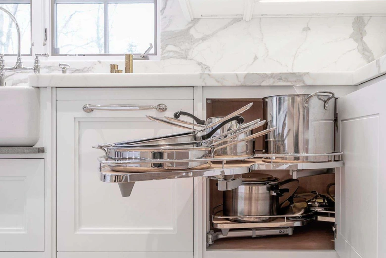Functional storage solution through tilt-down drawers and narrow pullouts.
