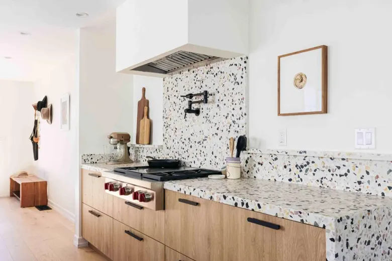 A modular kitchen interior design idea with terrazzo tiles.
A modular kitchen interior design idea with terrazzo tiles.