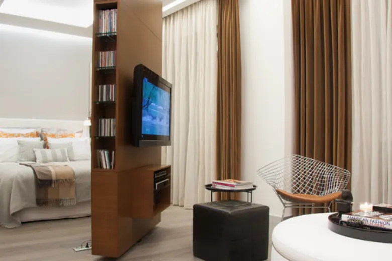 Contemporary bedroom equipped with smart technology like automated lighting and a voice-activated assistant.