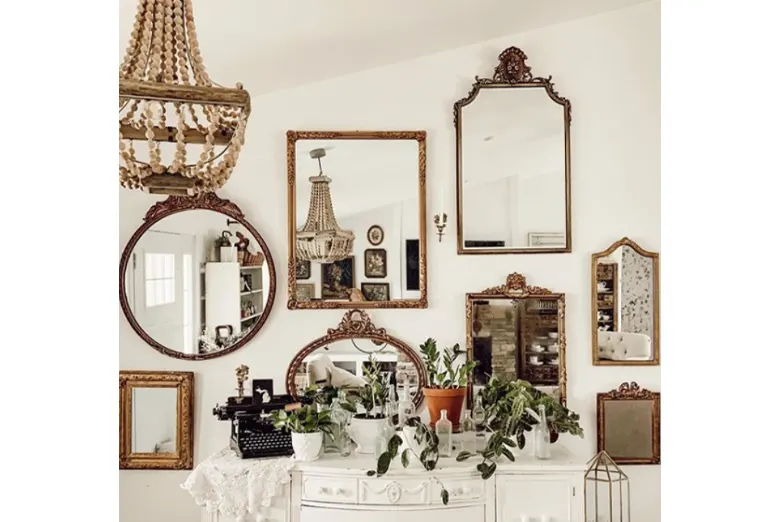 A room with mirrors used as decorations on the wall.