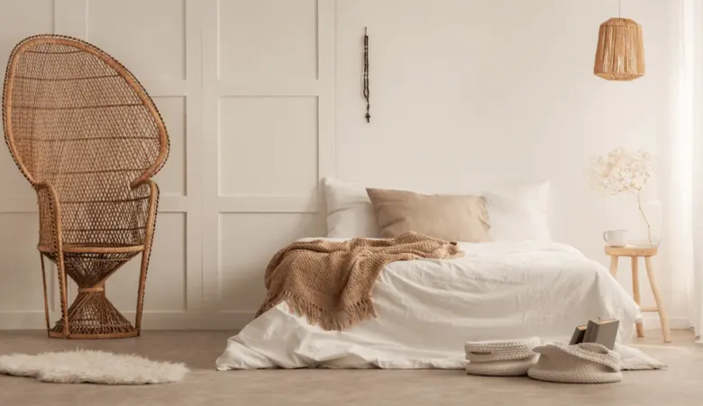 Stylish bedroom incorporating natural materials such as hardwood flooring, stone fireplace, and house plants.