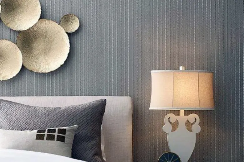 Bedroom featuring a sophisticated textured wall with reclaimed wood panels and plush bedding.