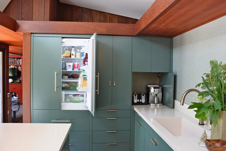 Fridge integrated into the cabinetry to reduce visual bulkiness