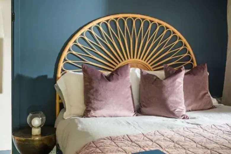 Elegant bedroom showcasing gold accents with picture frames, lamp bases, and a gold accent wall.