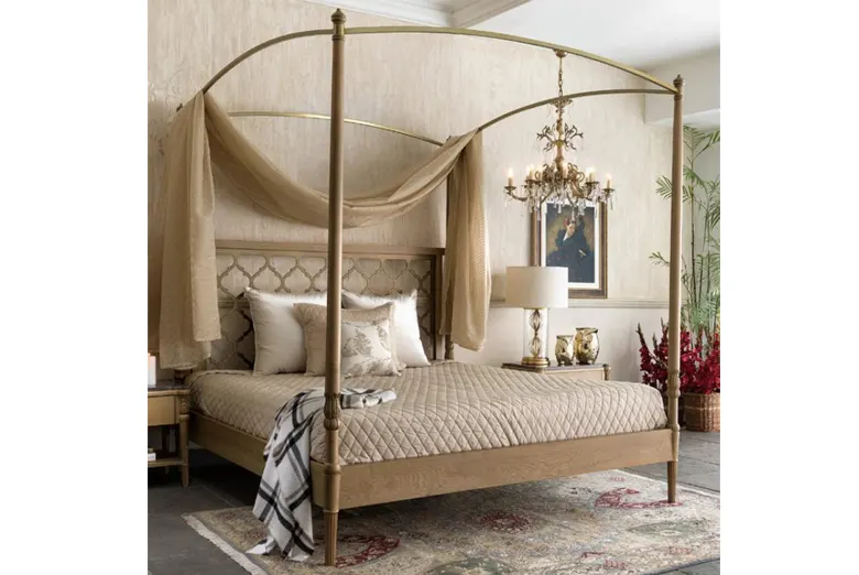 A light-coloured, four-poster canopy bed.
