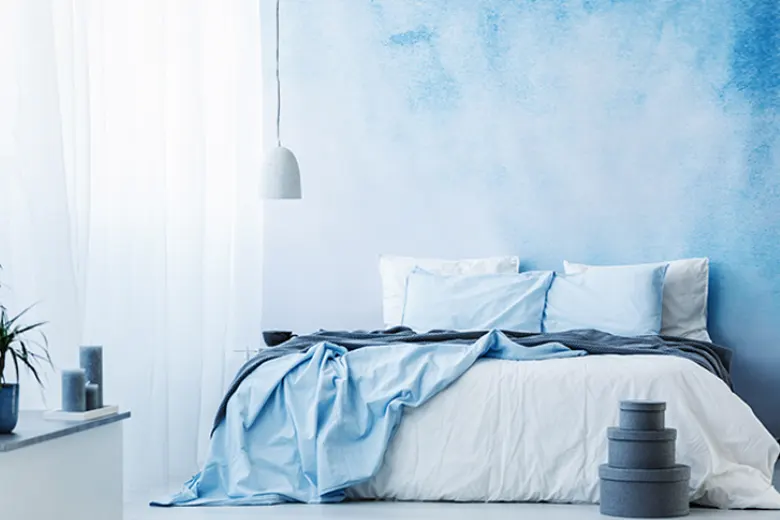 Modern bedroom featuring various shades of blue, creating a soothing and relaxing atmosphere.