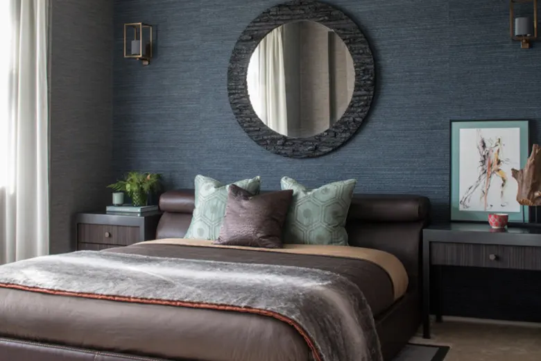 Inviting bedroom with layered textures of throws, rugs, and wall art adding depth and warmth.
