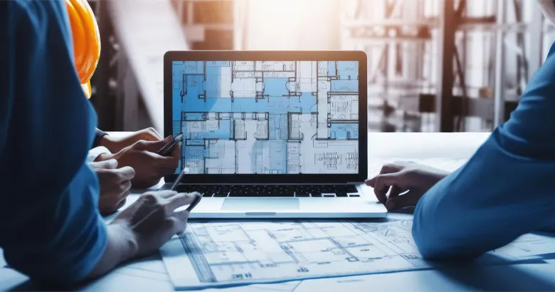 A civil engineer turned interior designer reviewing floor plans with the team