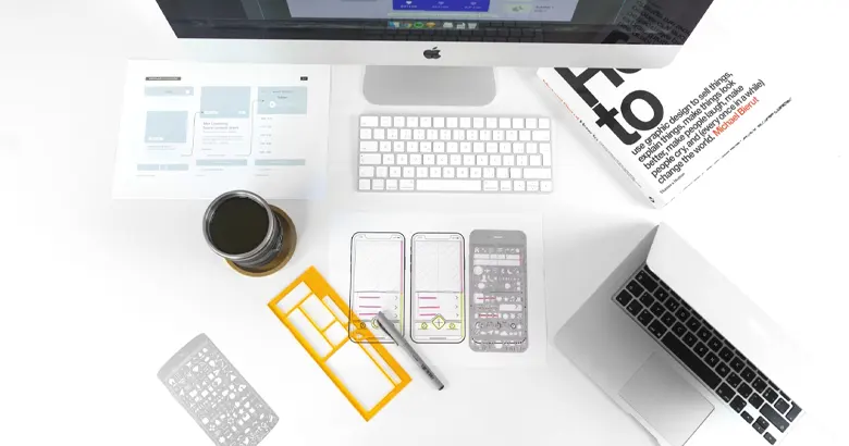 A designer's workstation with low fidelity wireframe and other objects
