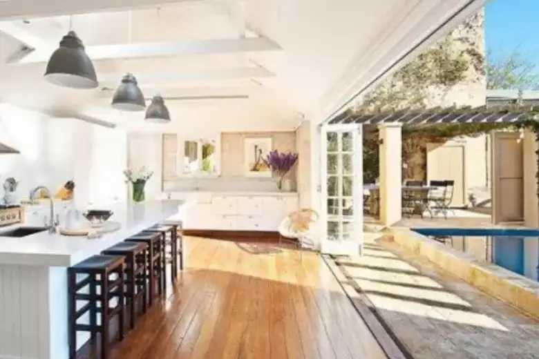 A spacious open kitchen with wooden flooring.
A spacious open kitchen with wooden flooring.