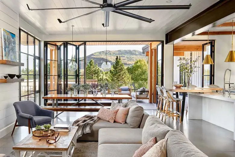 A home interiors with floor-to-ceiling windows and industrial style fan A home interiors with floor-to-ceiling windows and industrial style fan