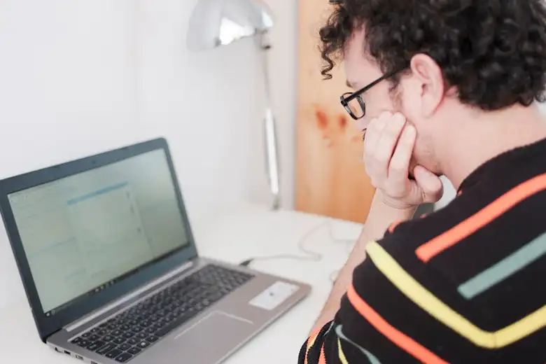 A graphic designer reviewing skills and salary information on their screen. A graphic designer reviewing skills and salary information on their screen.