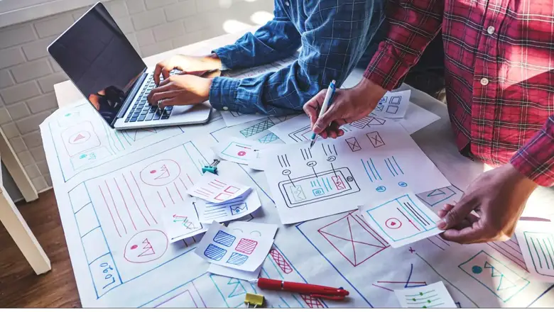 UI designers reviewing low fidelity wireframes UI designers reviewing low fidelity wireframes