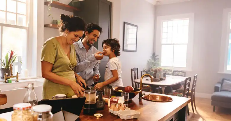 A family of three in an open kitchen.