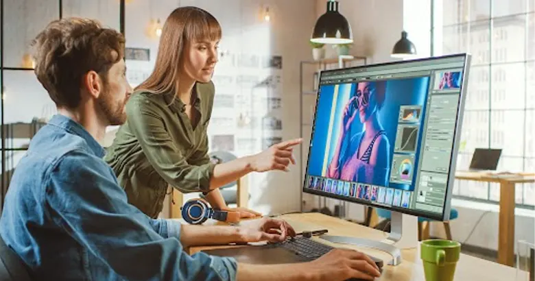 Middle Aged Photo Editor Works on a Desktop Computer using Photoshop