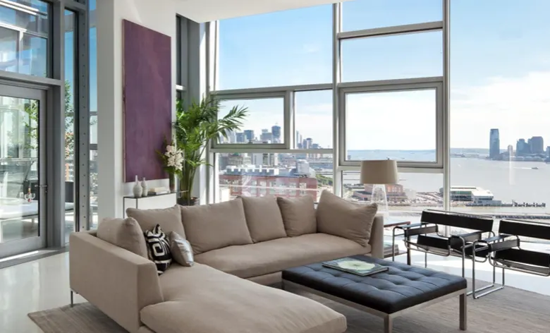 A luxury living room with floor-to-ceiling windows. A luxury living room with floor-to-ceiling windows.
