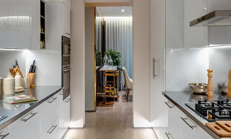 An Indian parallel kitchen with metal hardware for a sleek look.
An Indian parallel kitchen with metal hardware for a sleek look.