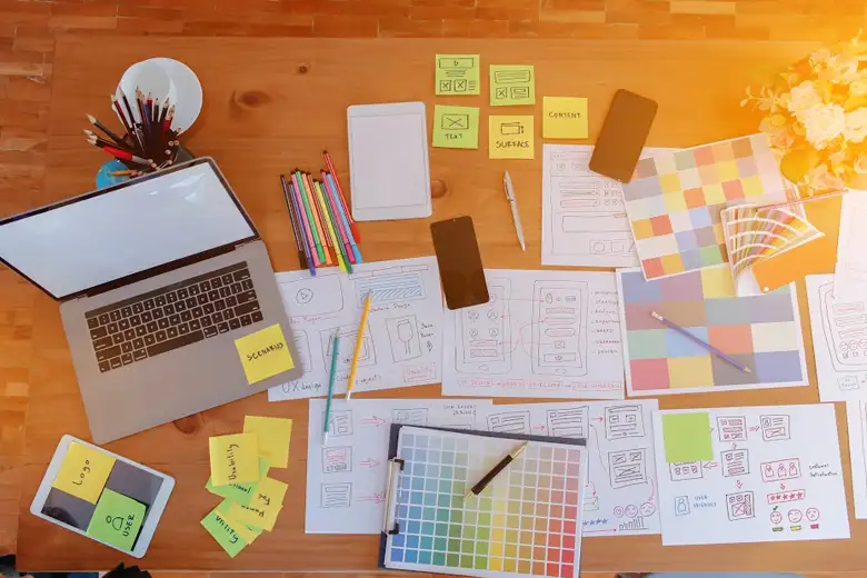 App development workspace with design thinking tools, sketches, wireframes, and prototypes for efficient, error-free UX/UI design.