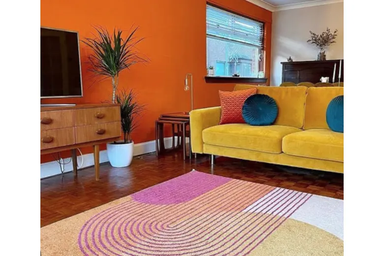 A living room with bold, patterned rugs.
A living room with bold, patterned rugs.