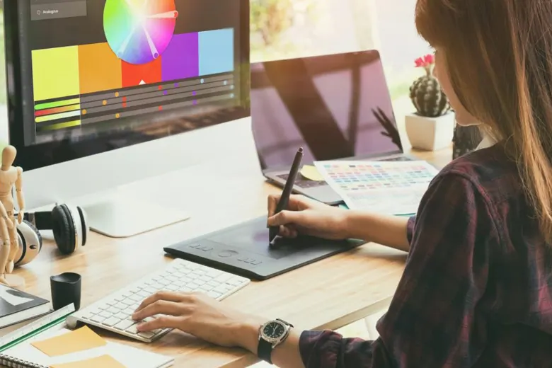 Graphic designer working with a color wheel.
Graphic designer working with a color wheel.