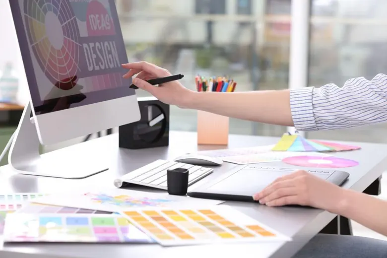 A graphic designer working on a design in their office. A graphic designer working on a design in their office.