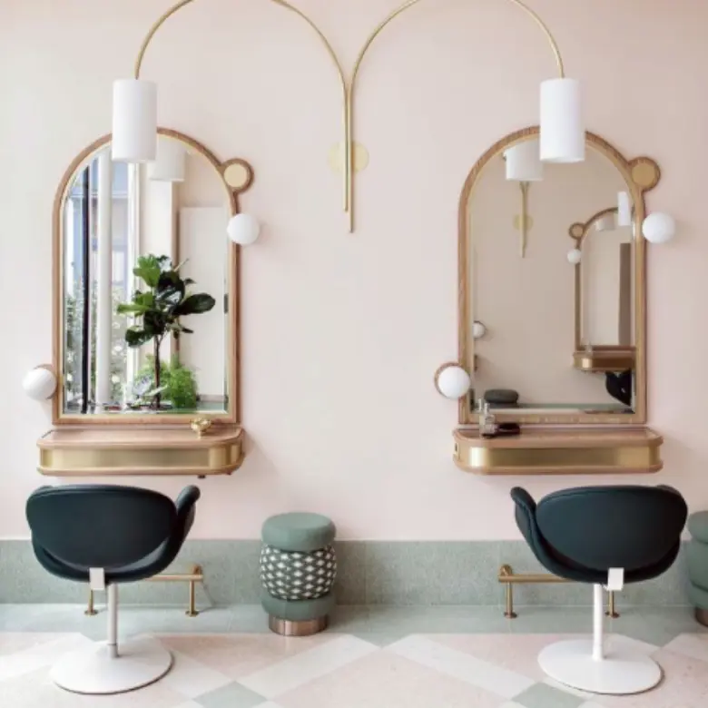 Salon interior featuring art deco touches with metallic finishes and rich materials for elegance.
