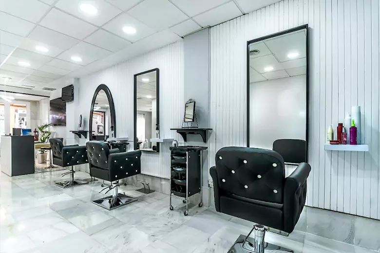 Salon interior featuring a clean design with black chairs, bright lighting, and sleek, modern decor Salon interior featuring a clean design with black chairs, bright lighting, and sleek, modern decor