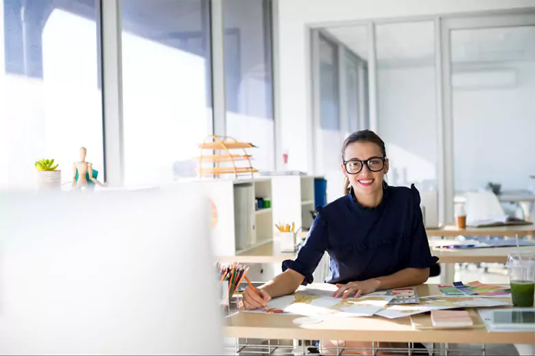 A graphic designer working in a office.
