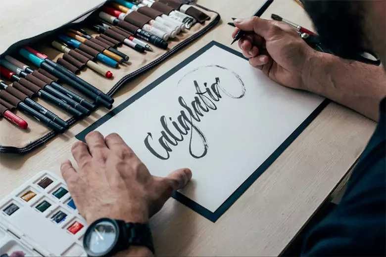 A graphic designer working on creating vintage style fonts.