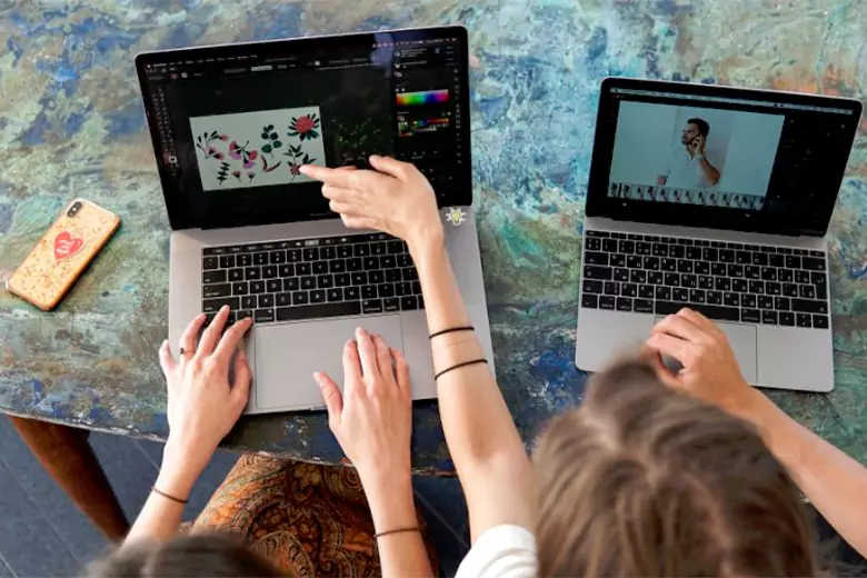 Two young female employees exploring color grading techniques for pictures.
Two young female employees exploring color grading techniques for pictures.