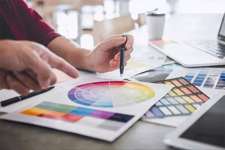 A designer working with color wheel.