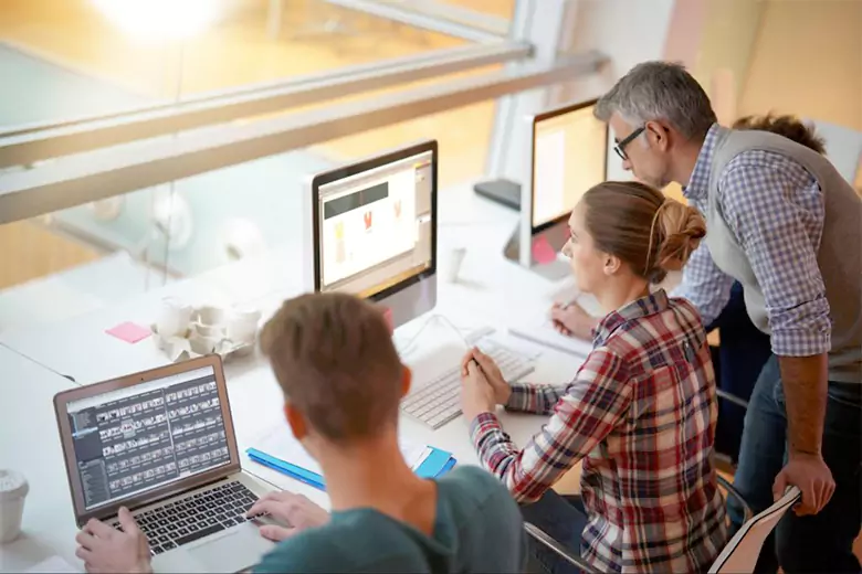 An instructor instructing students about graphic design principles. An instructor instructing students about graphic design principles.