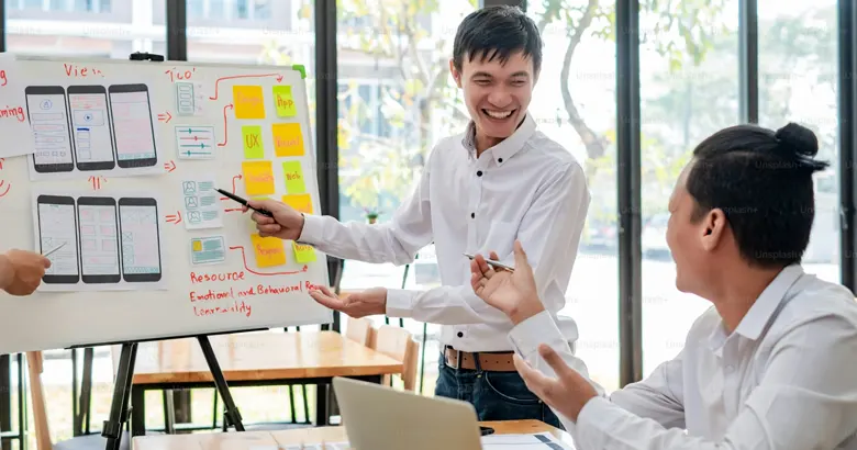 UX designers working on developing a mobile app wireframe.