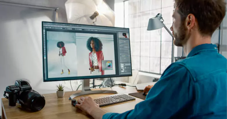 Freelancer practicing design skills with Adobe Photoshop on a laptop screen.
