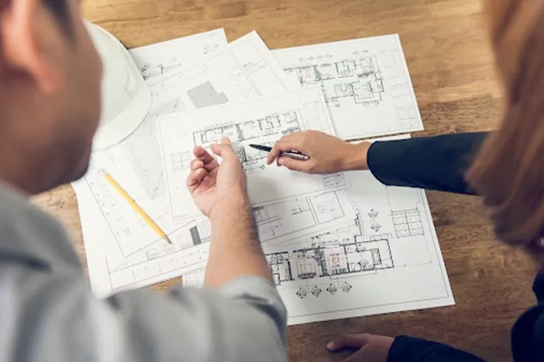 Two designers planning an interior design project with free tools, using an architectural map for a seamless design process. Two designers planning an interior design project with free tools, using an architectural map for a seamless design process.