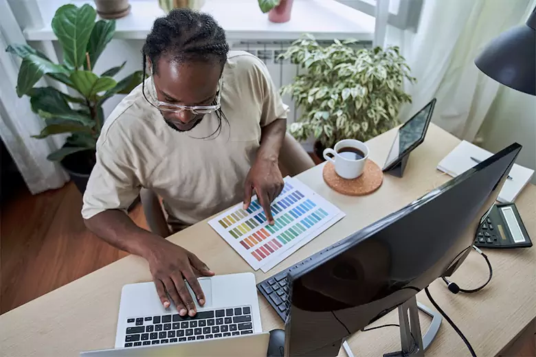Graphic designer reviewing a color palette for a project while working remotely.
Graphic designer reviewing a color palette for a project while working remotely.