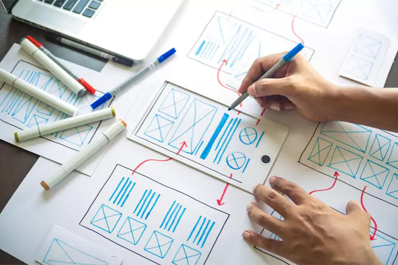 Designer finalizing an app wireframe. Designer finalizing an app wireframe.