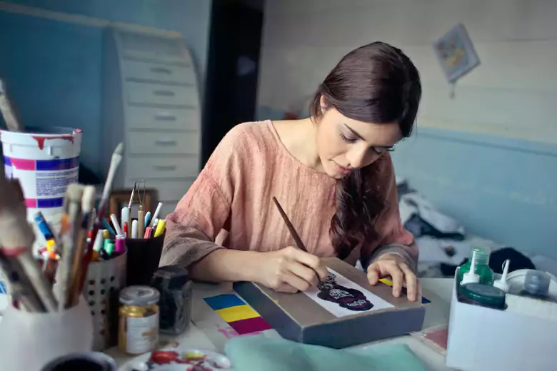 Student sketching an image as part of her creative process for a graphic design program