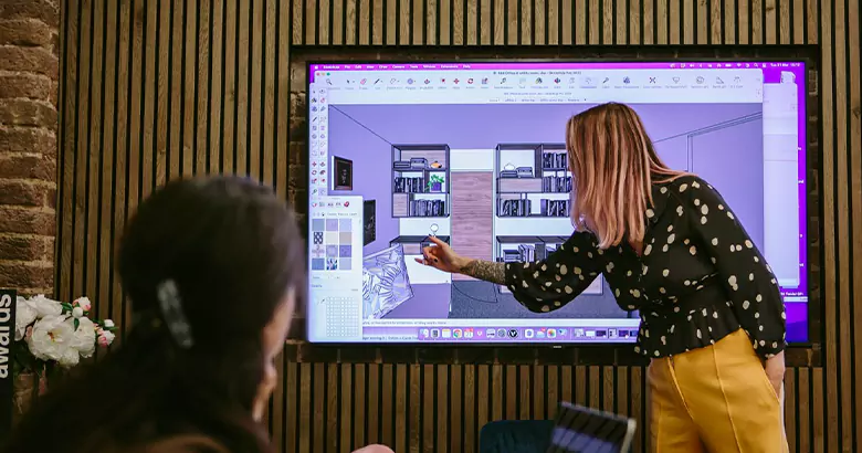 An interior designer explaining her design to a client.