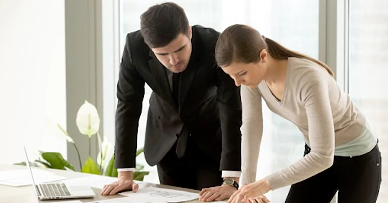 Young professionals reviewing a blue color palette for their brand and logo design.