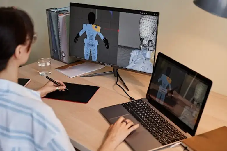 Young digital artist creating motion graphics on a computer.
