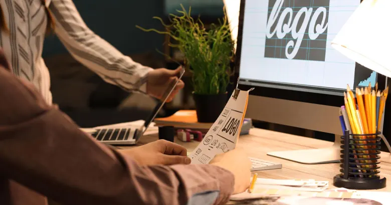 Picture of two designers working on logo concepts.