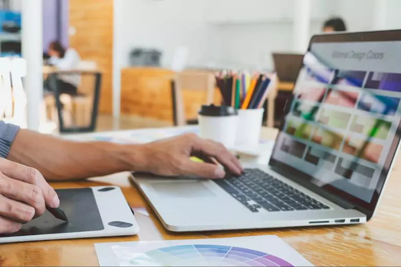 A visual communication designer working on his laptop