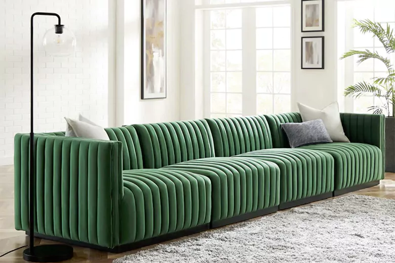 Picture of a green sectional sofa in a bright, modern living room, showcasing modern furniture design.