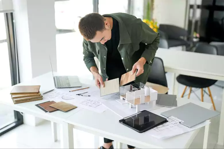 An interior stylist working in his office An interior stylist working in his office