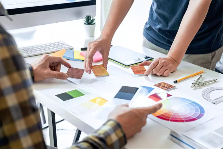 Two visual communication designers working with color wheel.
