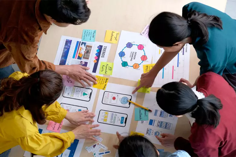 Group of visual communication designers working on creating a wireframe.
